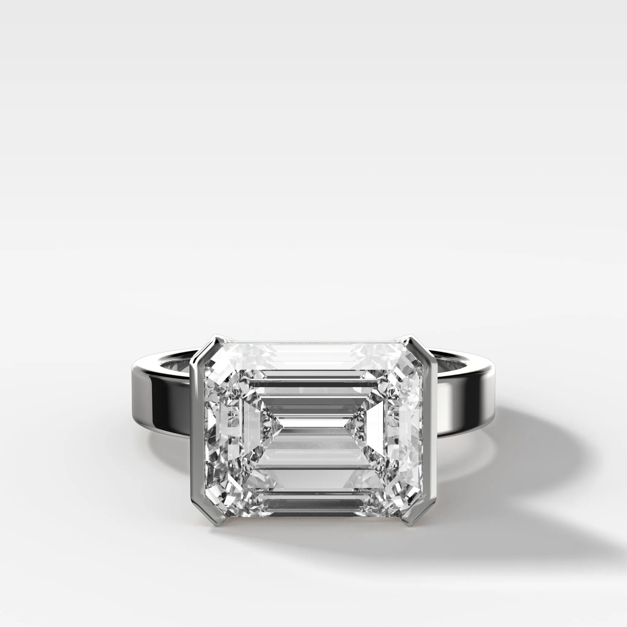Finest Half Bezel Solitaire Engagement Ring With East West Emerald Cut Diamond